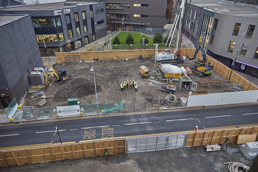 Aerial view of the construction site for the final office building at the @TheDock tech campus