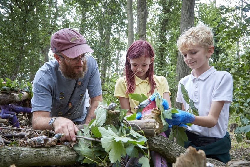 Artist Louis Dorton with school children at Bridgehead woodland trail